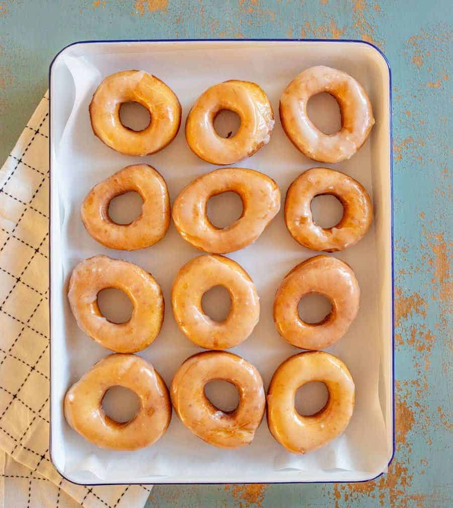 Beth's Famous Glazed Yeast Donuts are light, fluffy, easy to make, and done in just a few hours with a rich and creamy glaze to go on top.