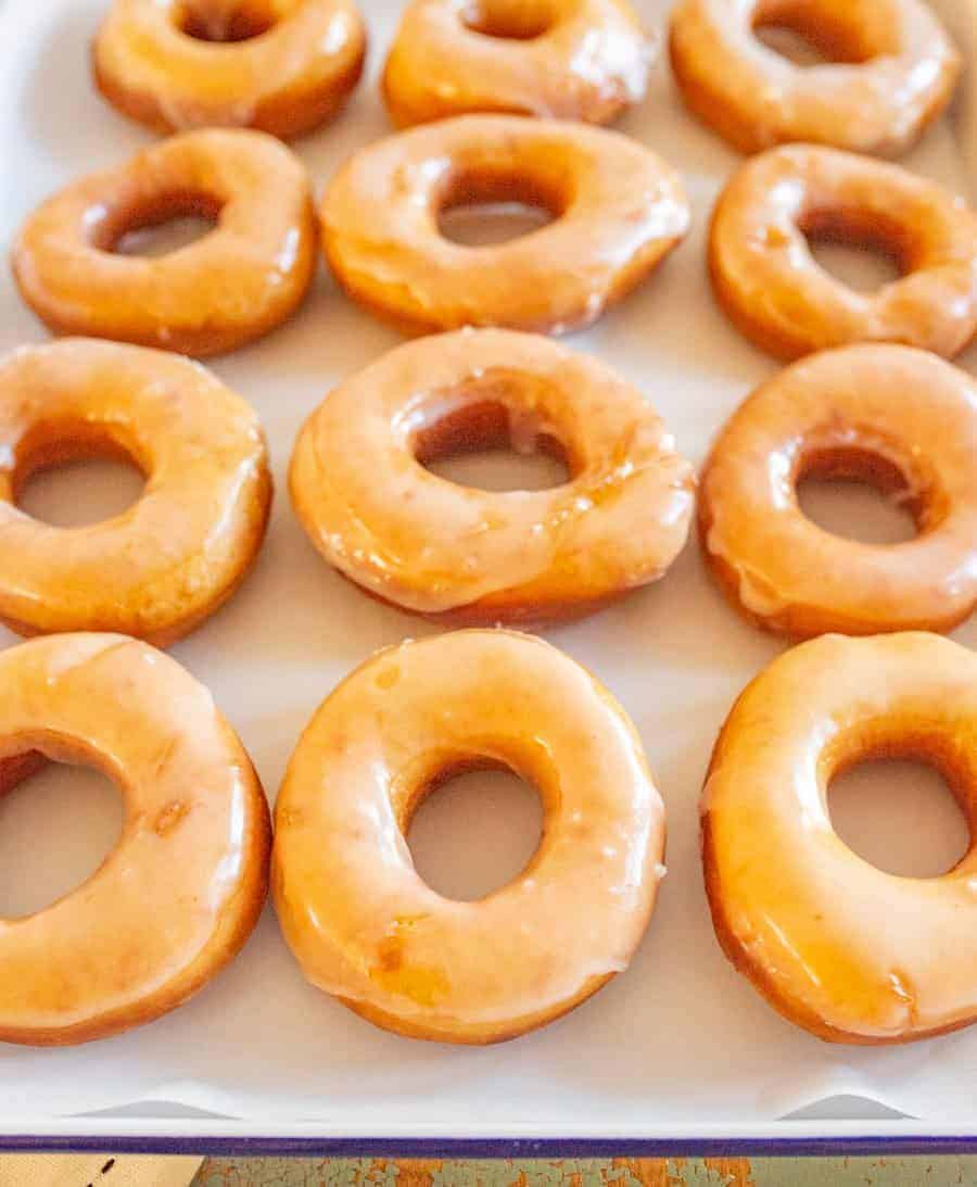 Beth's Famous Glazed Yeast Donuts are light, fluffy, easy to make, and done in just a few hours with a rich and creamy glaze to go on top.