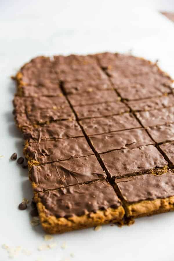 Chocolate Peanut Butter Oatmeal Cookie Bars with a shiny chocolate topping, cut into square, ready to be enjoyed.