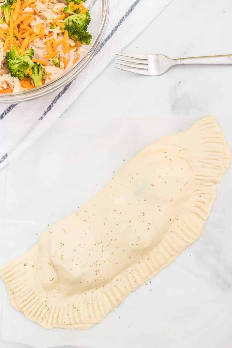 Cheesy chicken and broccoli calzones are gooey bites of pizza-reminiscent goodness that are easy to make and enjoy!