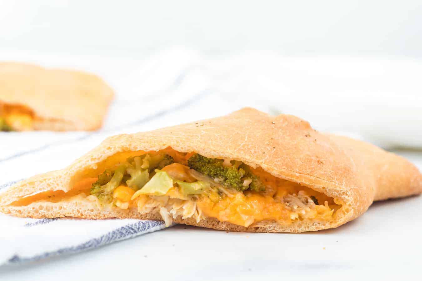 Cheesy chicken and broccoli calzones are gooey bites of pizza-reminiscent goodness that are easy to make and enjoy!