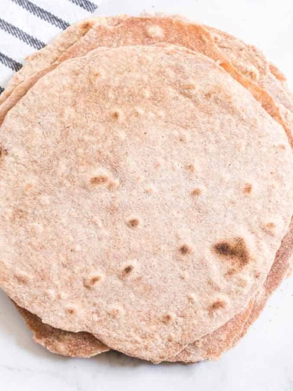 Hearty and healthy, whole wheat tortillas are beyond simple to make and go great with bold flavored wraps, tacos, and gyros!