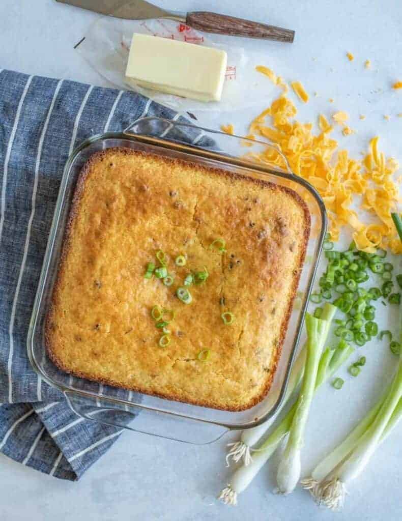 top view of the baking dish of cornbread with cheese and scallions