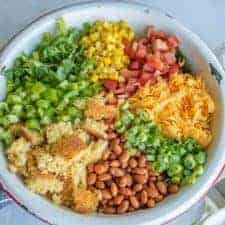 This cornbread salad has all of your favorite summertime flavors, like tomatoes, corn, pinto beans, and the star of the show, cornbread, and it's topped with a rich and creamy homemade ranch dressing! It's a perfect party dish.