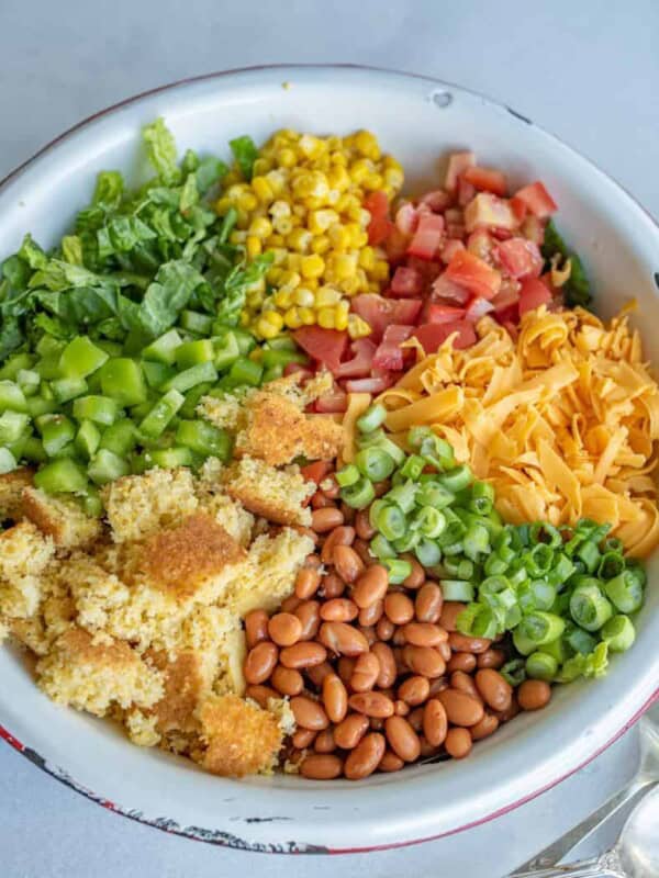 This cornbread salad has all of your favorite summertime flavors, like tomatoes, corn, pinto beans, and the star of the show, cornbread, and it's topped with a rich and creamy homemade ranch dressing! It's a perfect party dish.