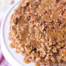 top view - oatmeal cake with sticky nut icing on top of a white cake stand