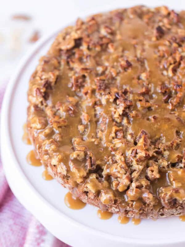 top view - oatmeal cake with sticky nut icing on top of a white cake stand