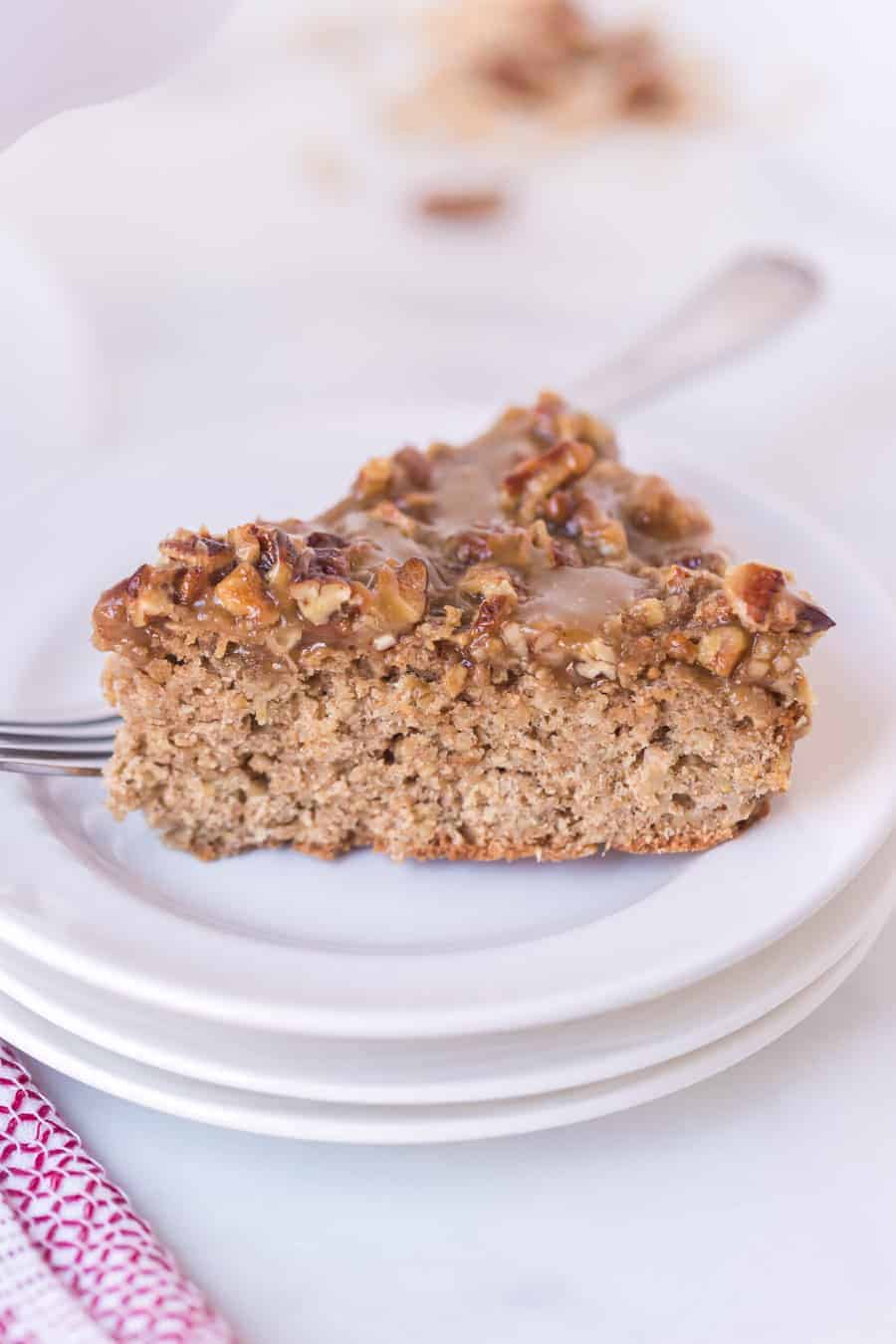 slick of oatmeal cake on white plate with fork