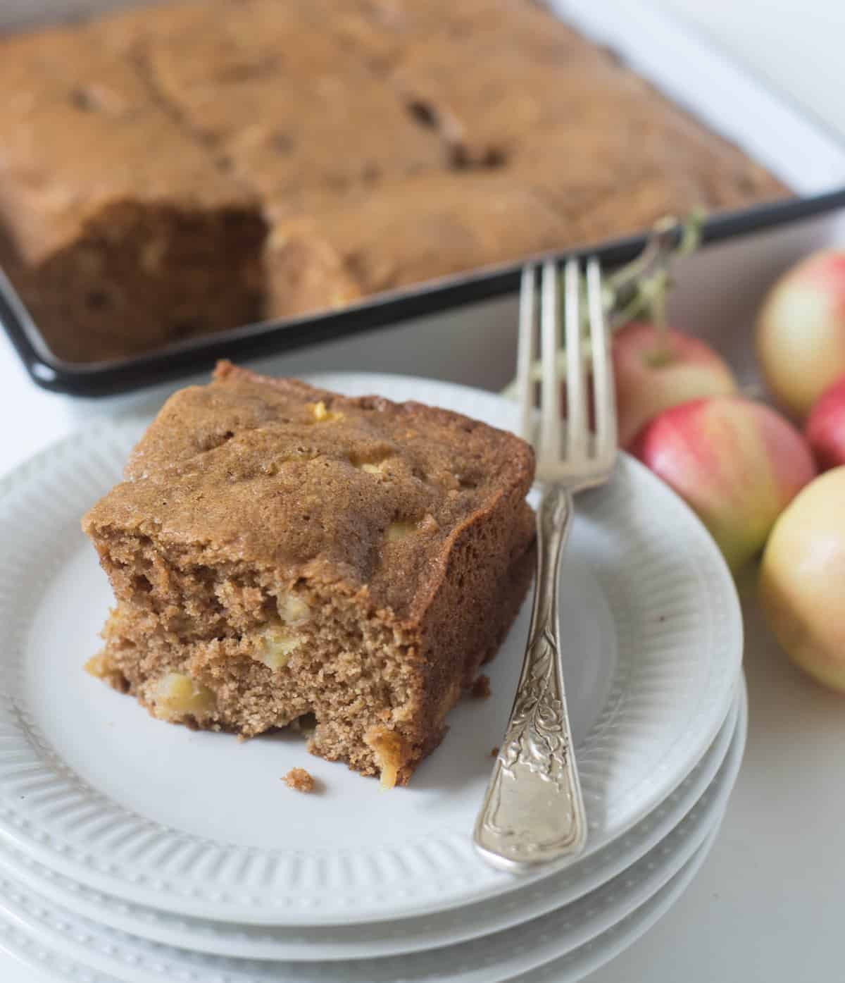 A plate with a square piece of easy apple cake and a fork