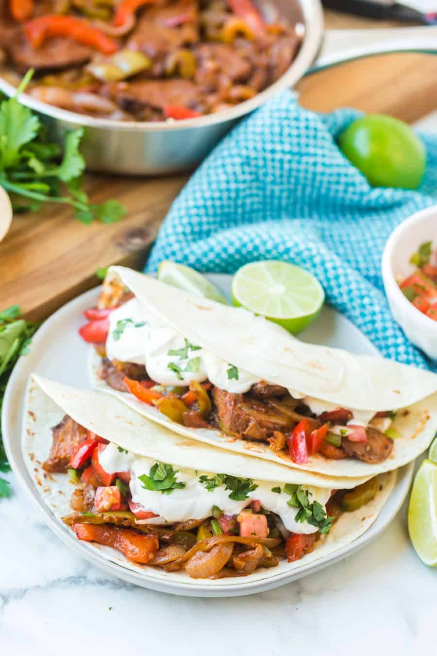 Easy steak fajitas come together fast with simple, fresh ingredients, including onion, peppers, salsa, pre-grilled steaks, and smoky, savory seasonings. #fajitas #steak #steakfajitas #texmex #mexicanfood #grilledsteak