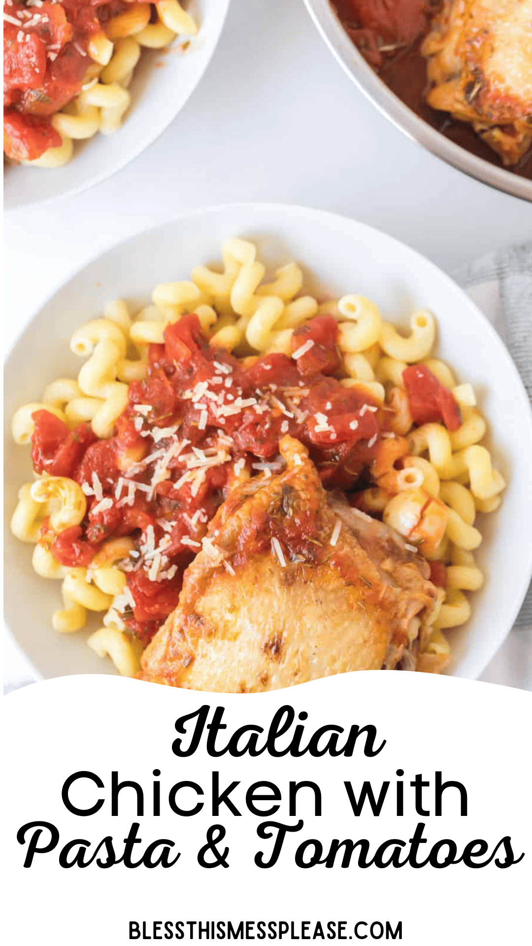 A bowl of curly pasta is elegantly topped with Italian chicken, diced tomatoes, and grated cheese. Nearby, a pan brimming with more chicken and tomatoes hints at the deliciousness that awaits in this Italian Chicken with Pasta & Tomatoes dish.
