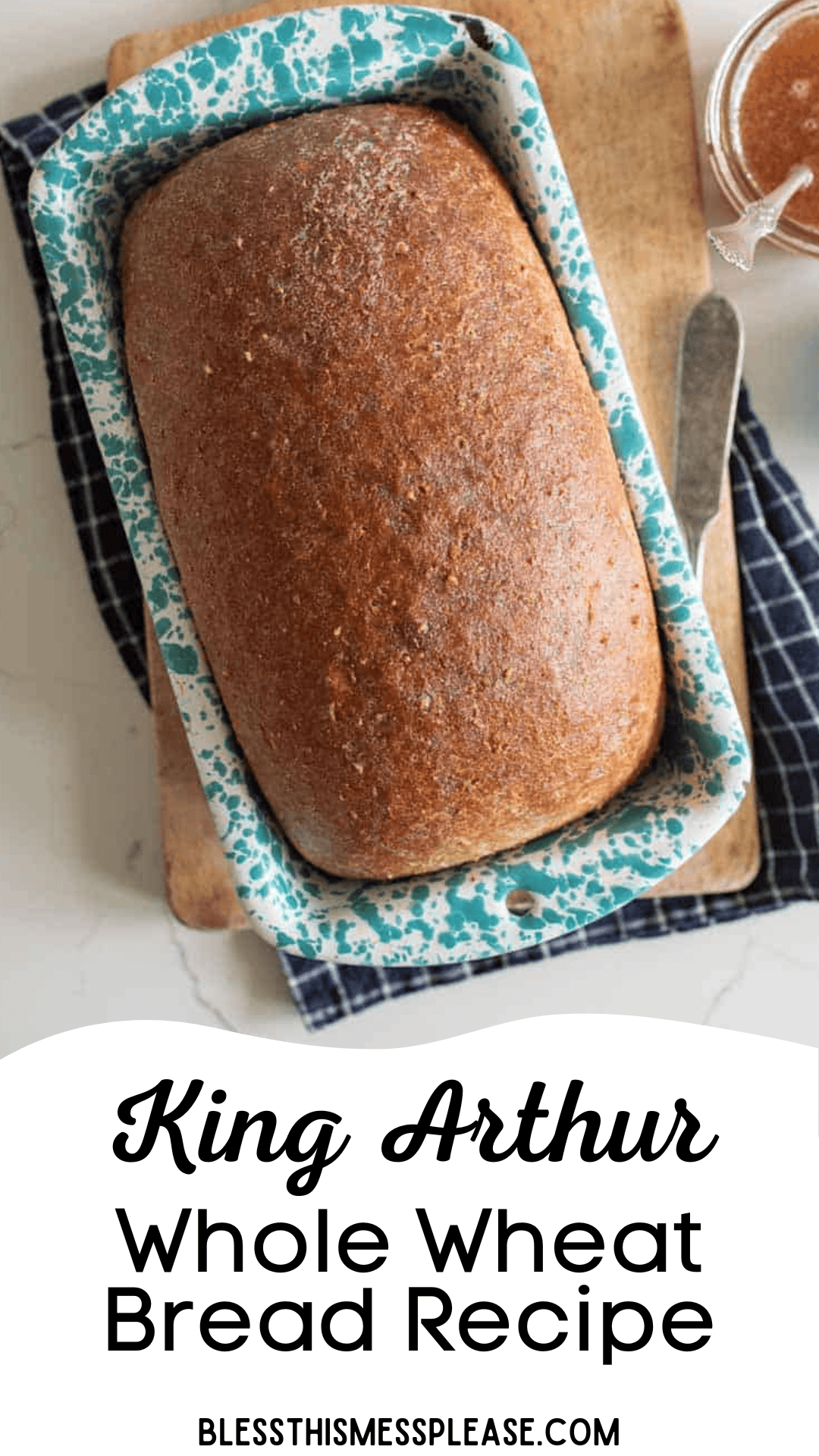 A loaf of whole wheat bread in a blue and white speckled pan sits on a wooden board, with a napkin and butter knife nearby. The text reads, King Arthur’s classic whole wheat bread recipe.