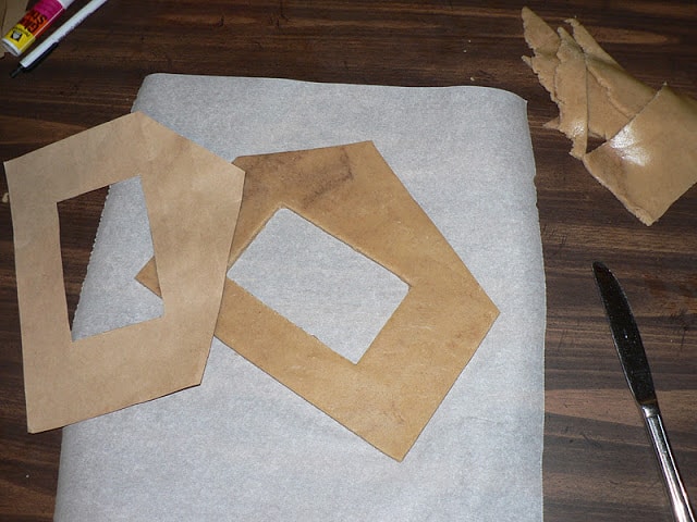 Gingerbread dough in the shape of a house on a sheet of parchment paper