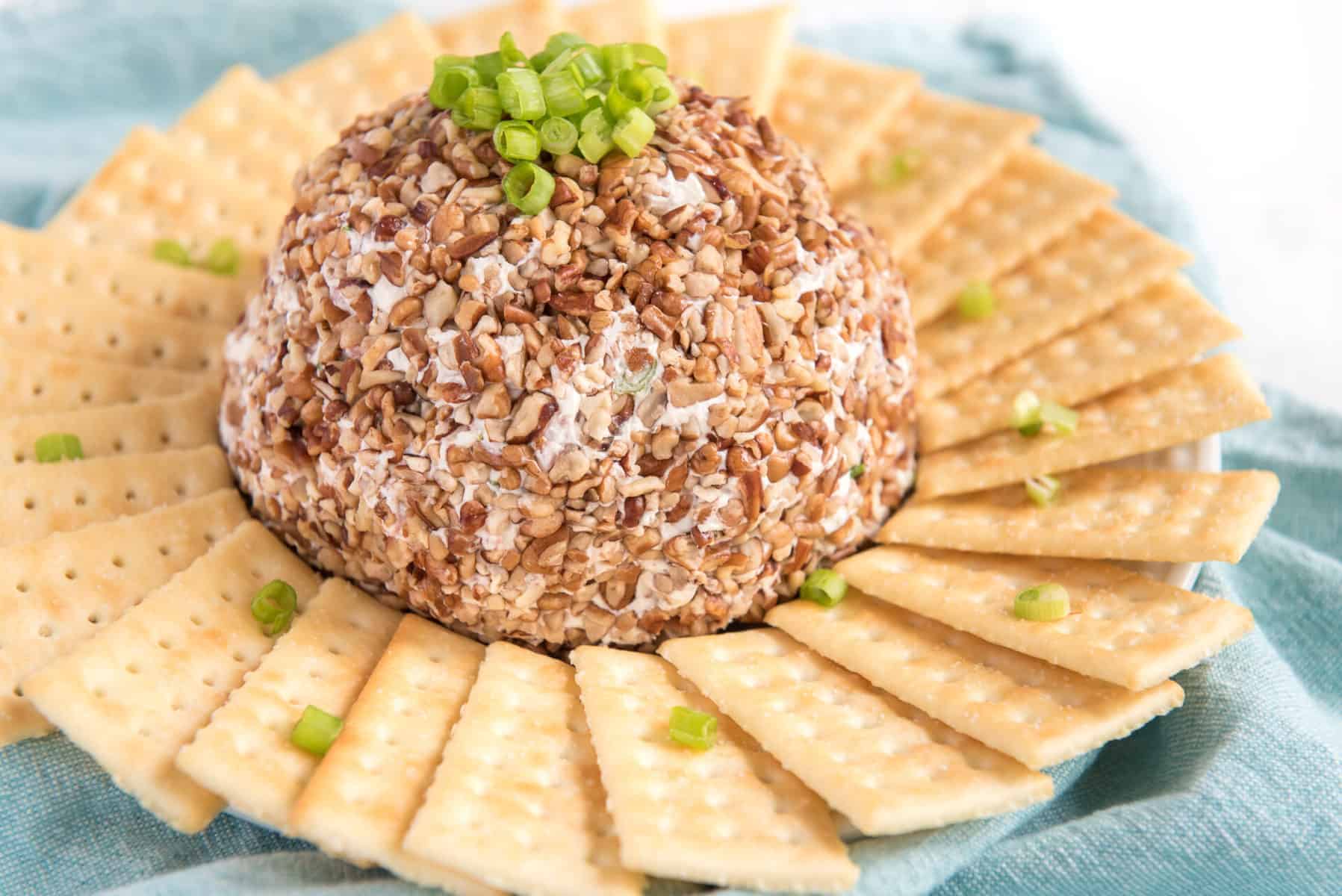 You can never go wrong with a cheese ball, especially when hosting a holiday gathering! Salty, crunchy, and cheesy, it's the perfect appetizer for guests to munch on as they visit with each other. I love how simple they are to throw together, and everyone loves snacking on them before a rich and hearty meal. #cheeseball #homemadecheeseball #cheeseballrecipe #easycheeseball #easyappetizer #partyappetizer #holidayappetizer