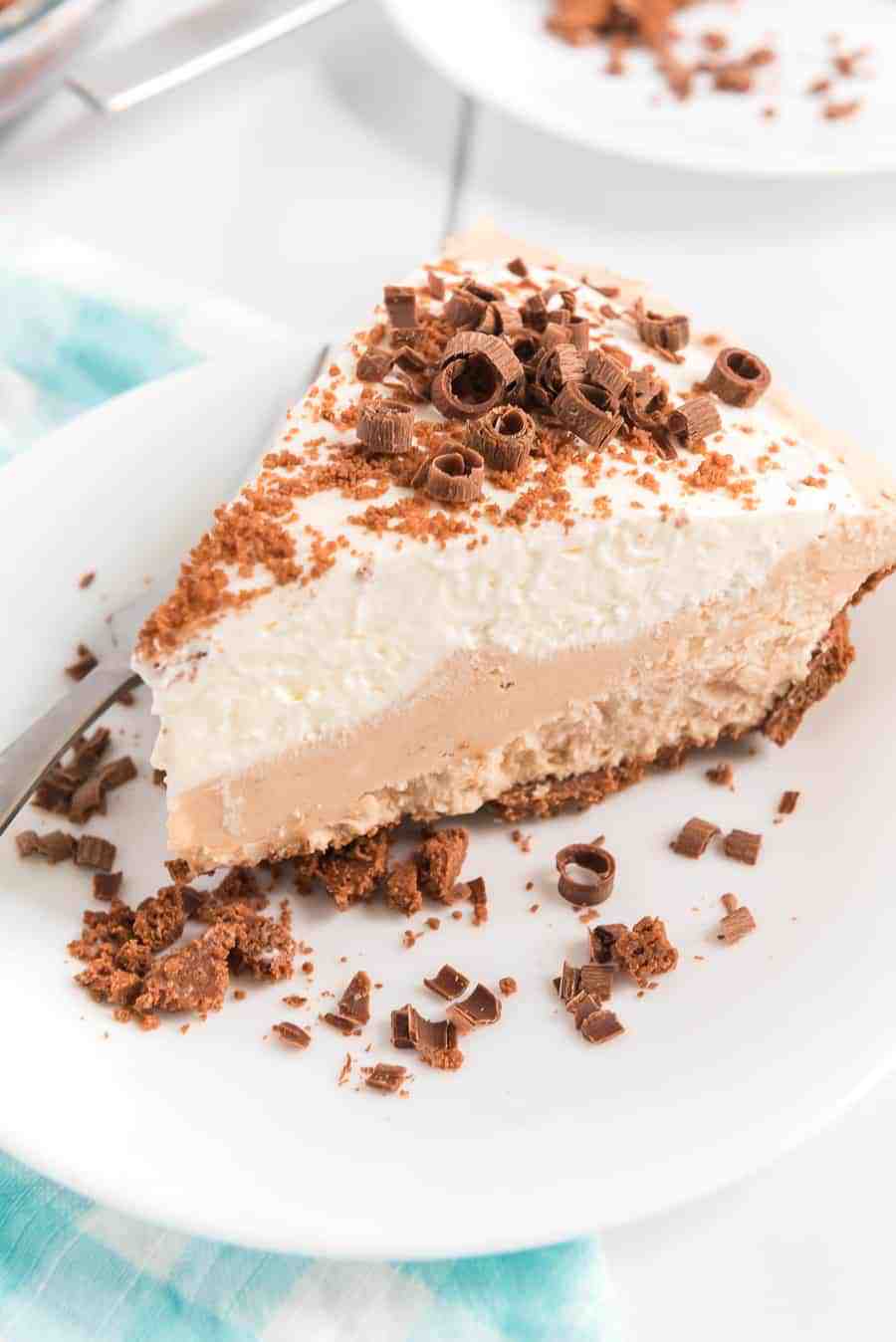 slice of pie on white plate with chocolate curls