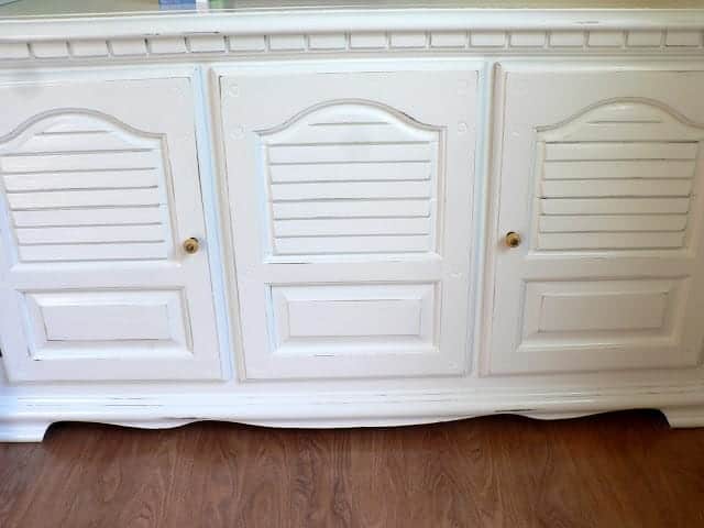 bottom piece of furniture hutch with doors pained white.