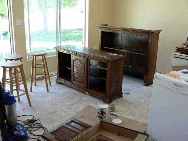 brown piece of furniture with doors and hinges removed being prepared for painting.