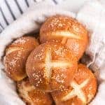 an overhead shot of some pretzel rolls in a linen lined bowl.