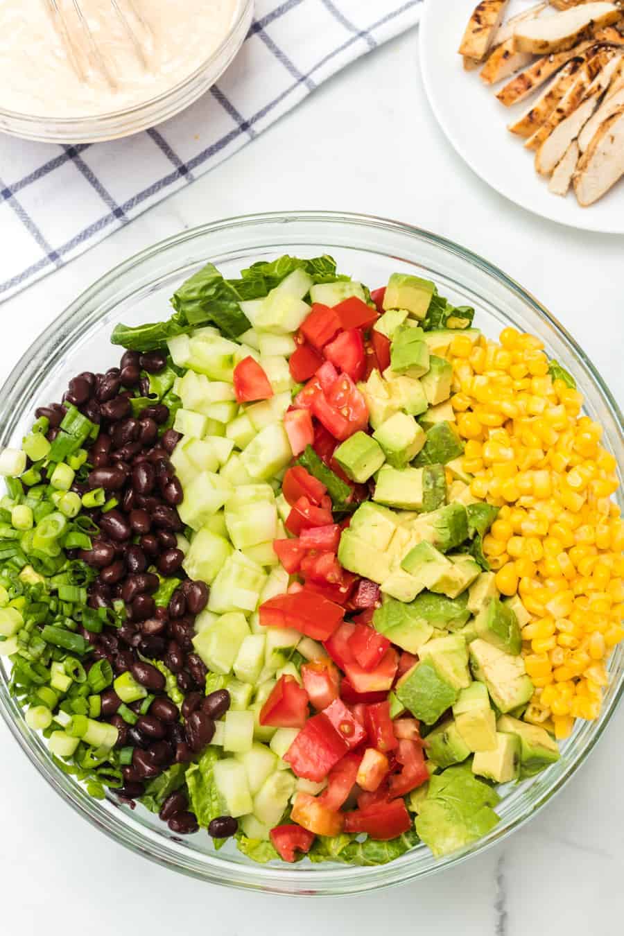 Barbecue ranch chicken salad is the most flavorful salad you'll ever eat, complete with a smoky and sweet dressing, grilled chicken, avocado, tomato, corn, romaine, and a whole lot of other vibrant veggies.