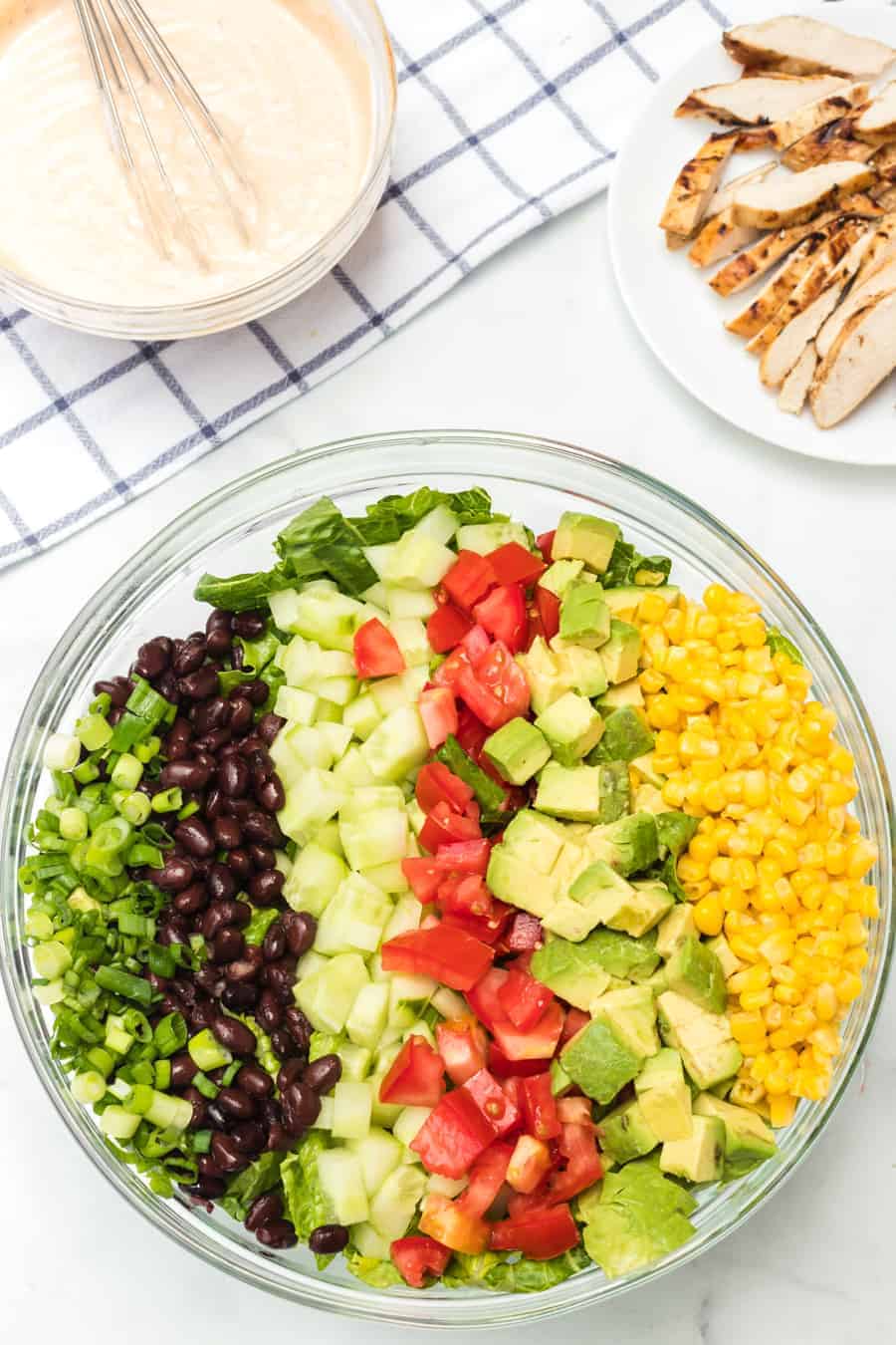 Barbecue ranch chicken salad is the most flavorful salad you'll ever eat, complete with a smoky and sweet dressing, grilled chicken, avocado, tomato, corn, romaine, and a whole lot of other vibrant veggies.