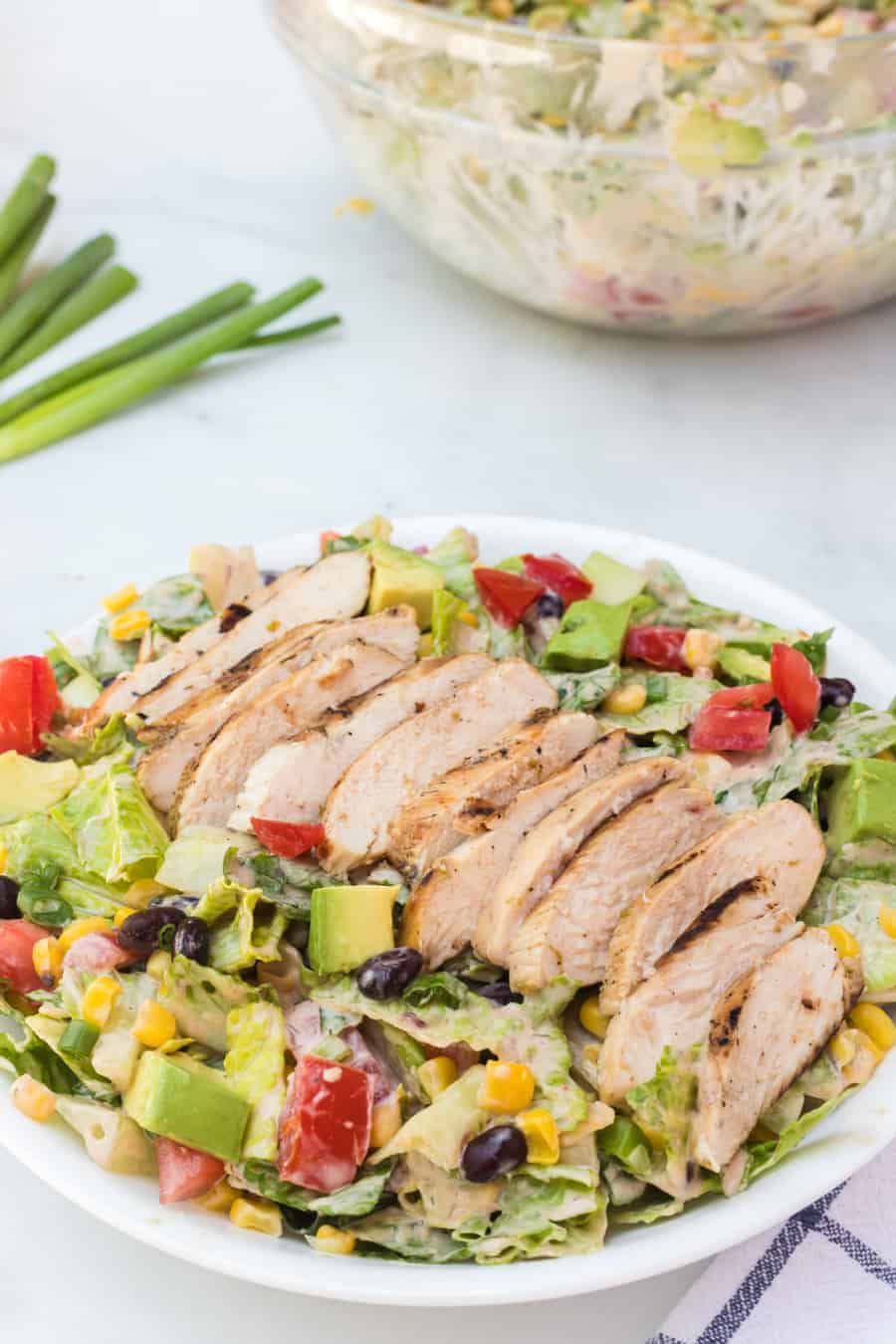 Barbecue ranch chicken salad is the most flavorful salad you'll ever eat, complete with a smoky and sweet dressing, grilled chicken, avocado, tomato, corn, romaine, and a whole lot of other vibrant veggies.