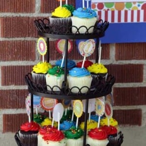 A cupcake tower with colorful circus-themed cupcakes
