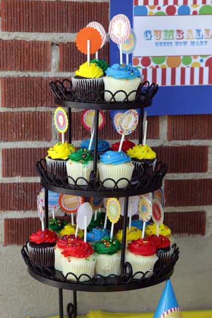 A cupcake tower with colorful circus-themed cupcakes