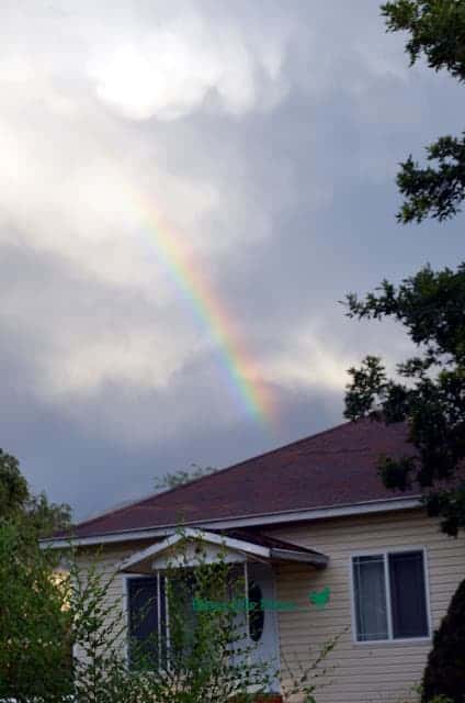 Rainbow behind a yellow house