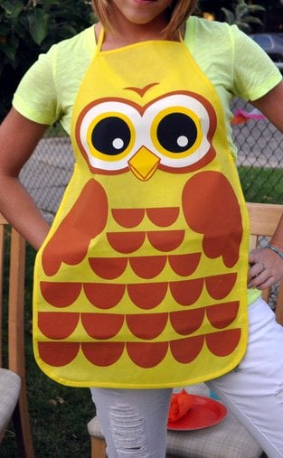 A woman wearing an owl apron