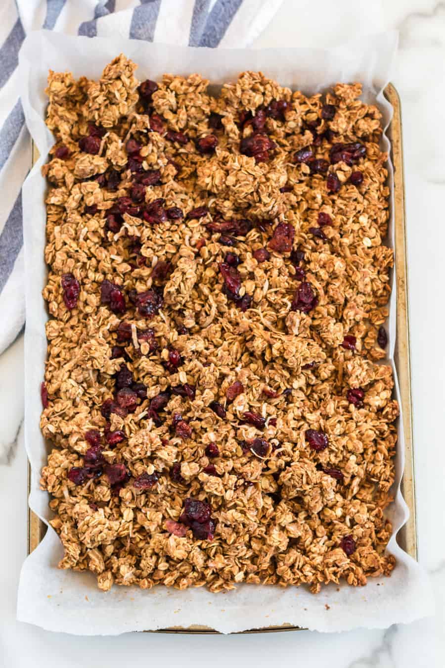 Cinnamon Granola is a simple snack that's bursting with mildly sweet and crunchy goodness, thanks to the oats, honey, shredded coconut, dried cranberries, cinnamon, vanilla, and nuts.