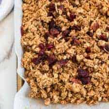 Cinnamon Granola is a simple snack that's bursting with mildly sweet and crunchy goodness, thanks to the oats, honey, shredded coconut, dried cranberries, cinnamon, vanilla, and nuts.