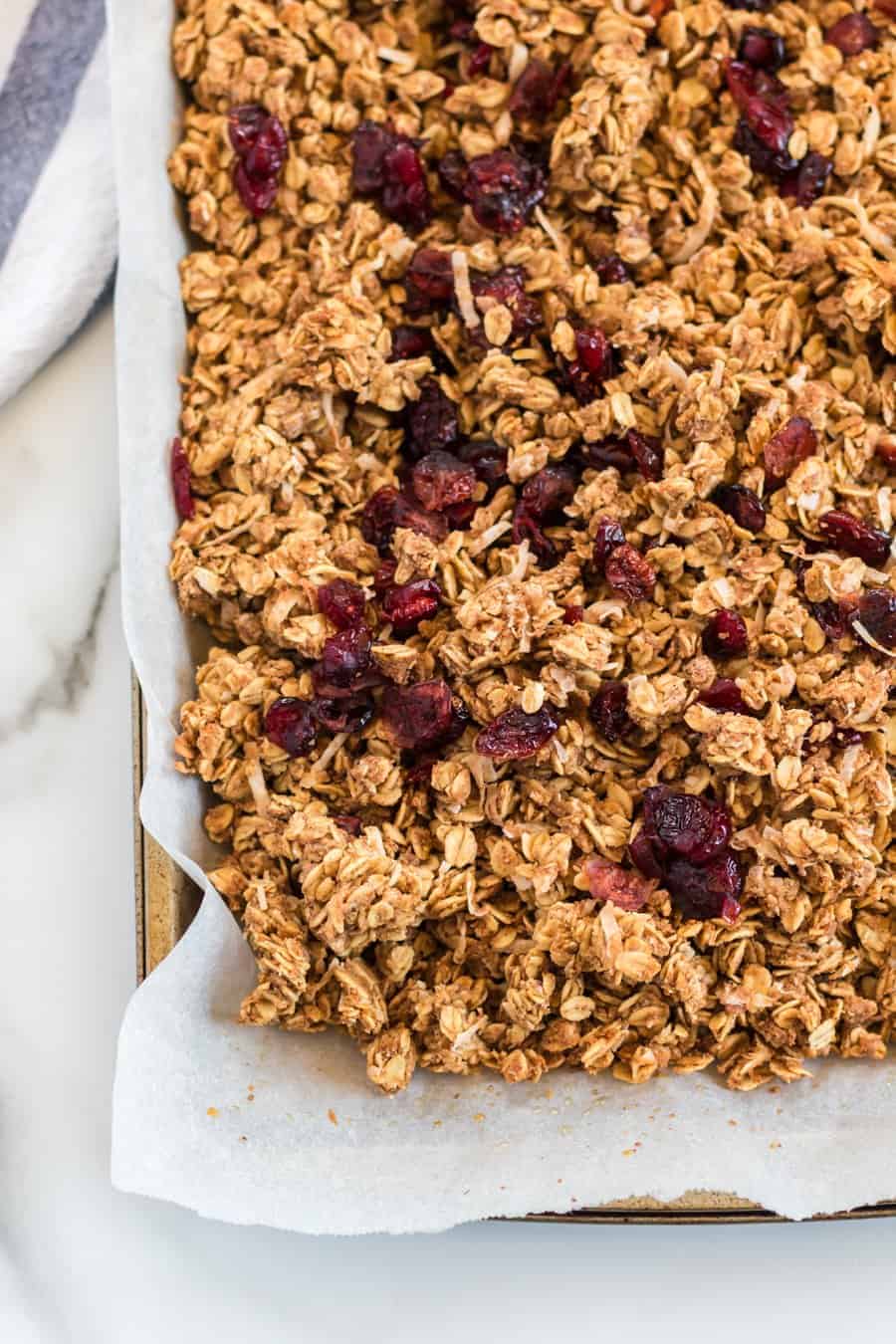 Cinnamon Granola is a simple snack that's bursting with mildly sweet and crunchy goodness, thanks to the oats, honey, shredded coconut, dried cranberries, cinnamon, vanilla, and nuts.