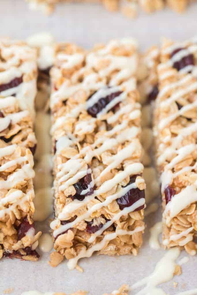 rectangles of cranberry granola bars on parchment