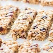 rectangles of cranberry granola bars on parchment