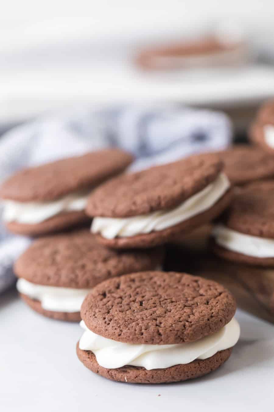 sandwich cookies made with a cake mix next to milk