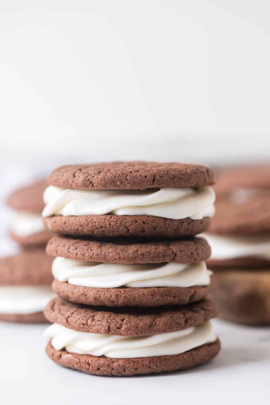 sandwich cookies made with a cake mix next to milk