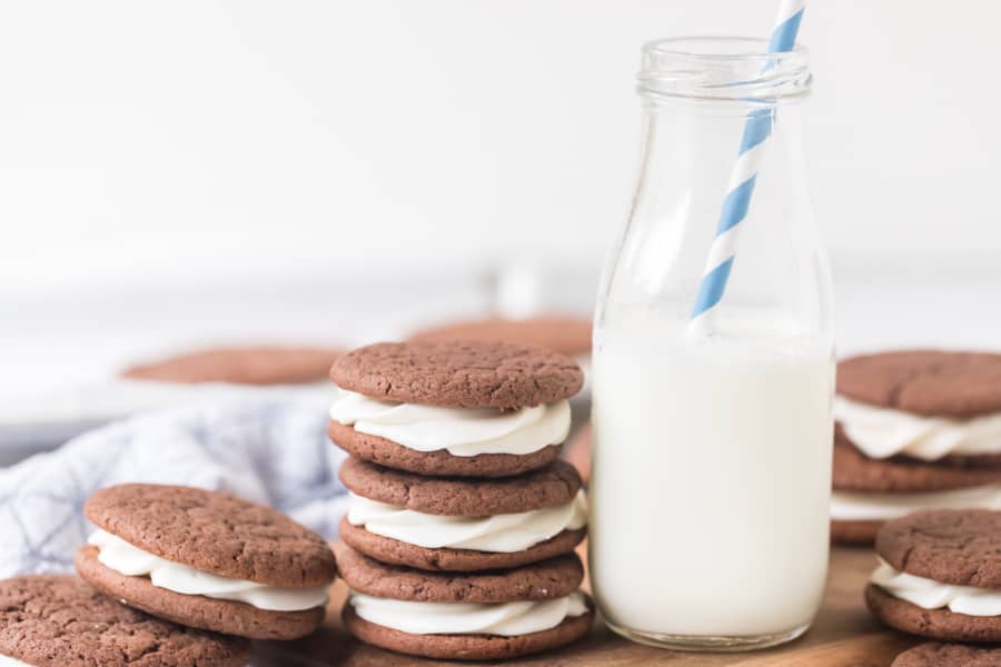 sandwich cookies made with a cake mix next to milk