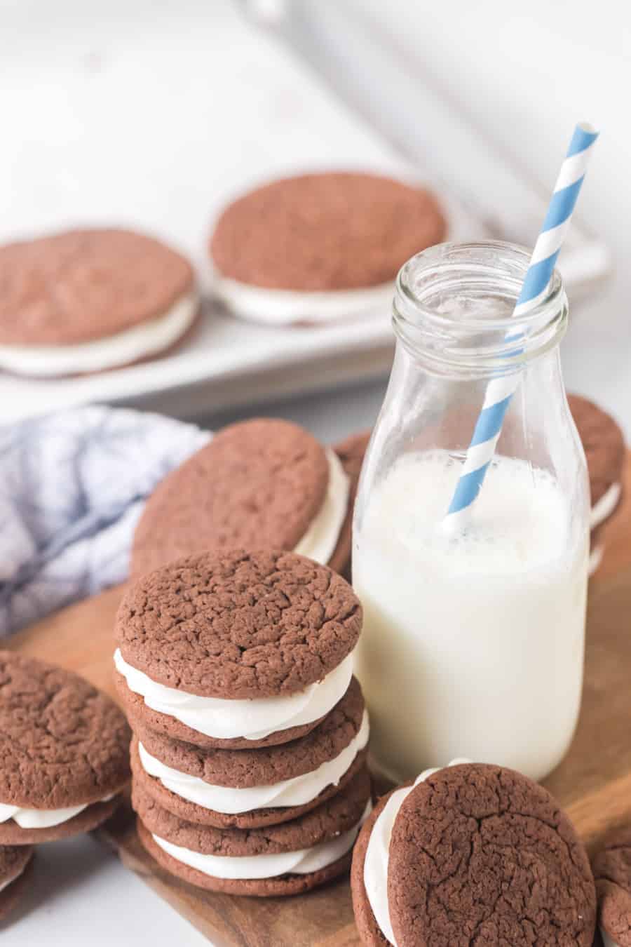 sandwich cookies made with a cake mix next to milk