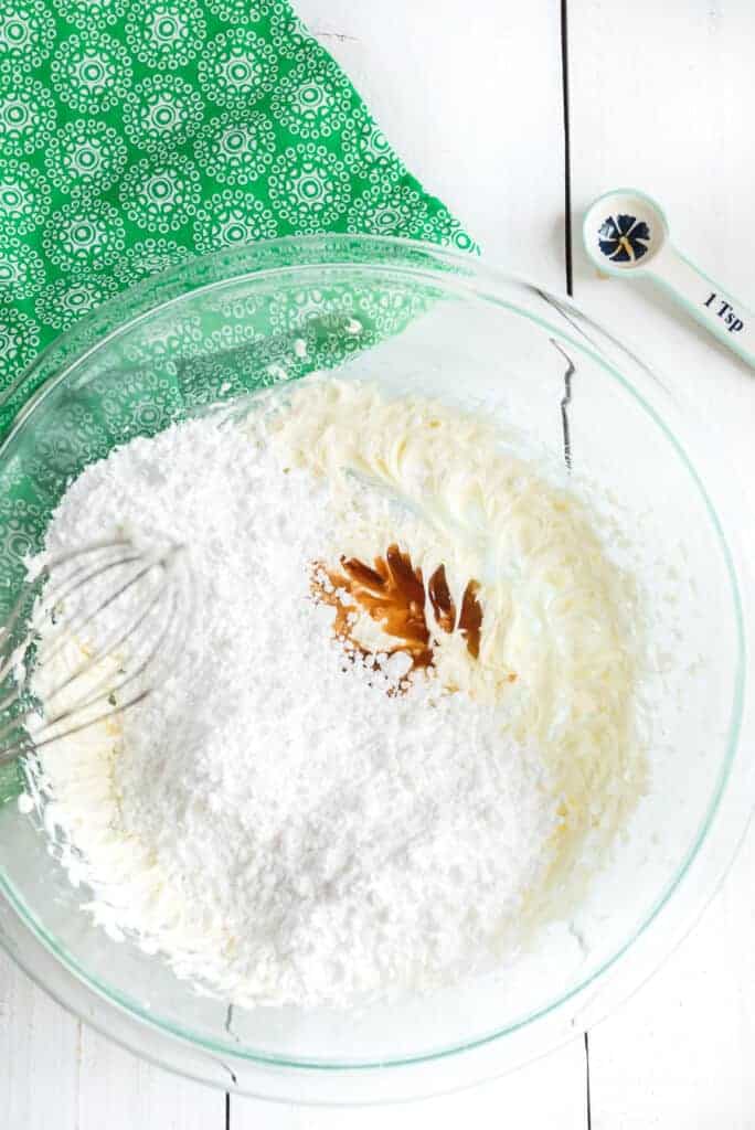 vanilla extract going into buttercream and powdered sugar for buttercream frosting