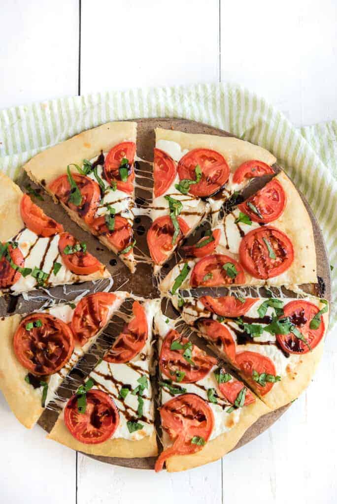 tomatos and balsamic reduction spread over a classic margarita pizza