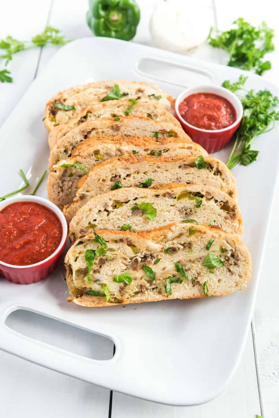 Cheesy Sausage and Pepper Stromboli made with homemade pizza crust, lots of sausage and cheese, and all rolled up into dippable pizza-like slices the whole family will love.
