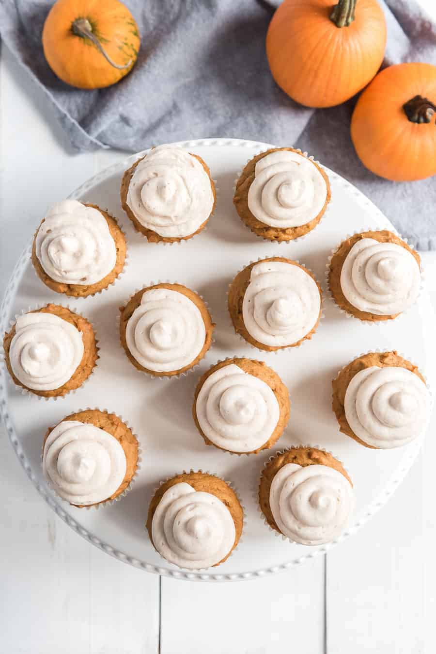 Pumpkin cupcakes with whipped cinnamon icing are perfect bites of fall-inspired sweetness, with just the right amount of pumpkin flavor and warm spices to round them out! #pumpkincupcakes #cupcakerecipe #fallrecipes #pumpkinrecipes #cinnamonfrosting #cupcakes 