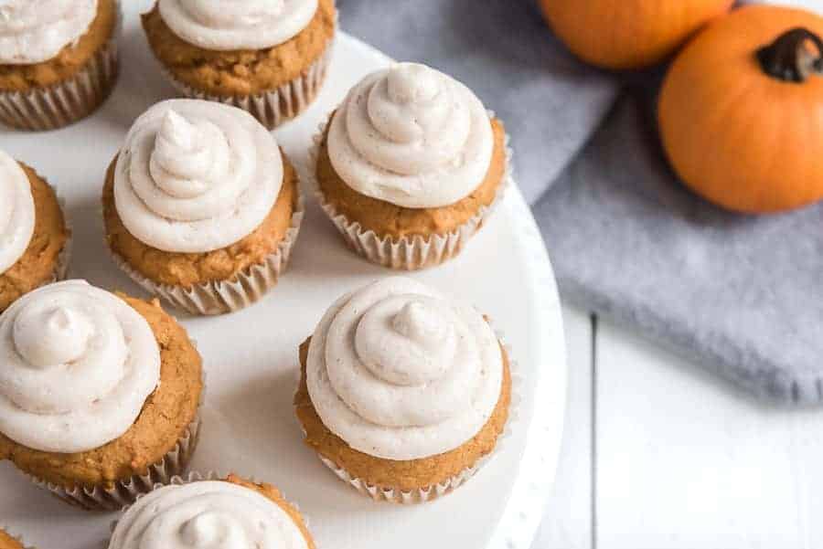 Pumpkin cupcakes with whipped cinnamon icing are perfect bites of fall-inspired sweetness, with just the right amount of pumpkin flavor and warm spices to round them out! #pumpkincupcakes #cupcakerecipe #fallrecipes #pumpkinrecipes #cinnamonfrosting #cupcakes 
