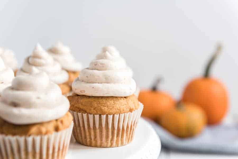 Pumpkin cupcakes with whipped cinnamon icing are perfect bites of fall-inspired sweetness, with just the right amount of pumpkin flavor and warm spices to round them out! #pumpkincupcakes #cupcakerecipe #fallrecipes #pumpkinrecipes #cinnamonfrosting #cupcakes 