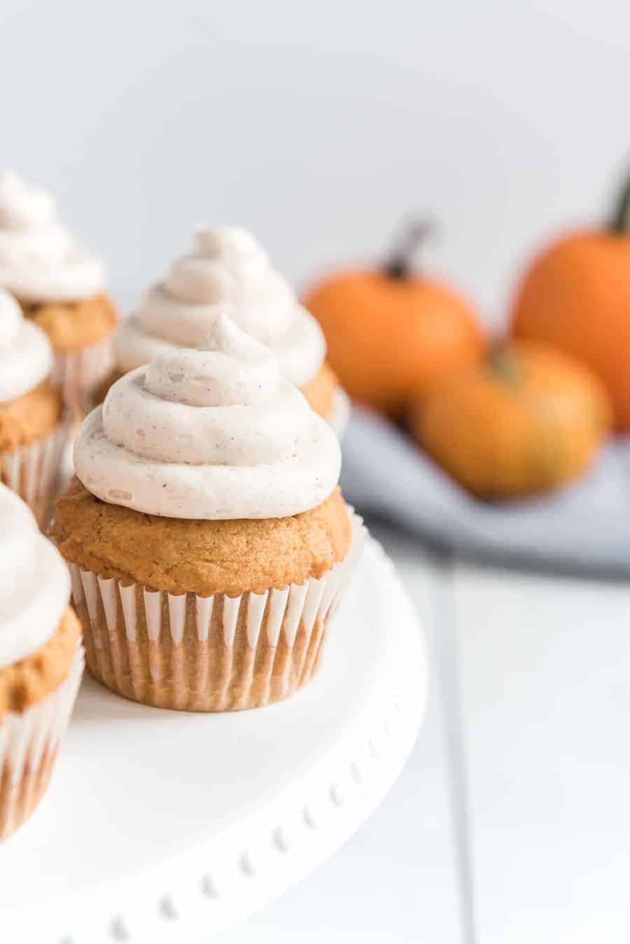 Pumpkin cupcakes with whipped cinnamon icing are perfect bites of fall-inspired sweetness, with just the right amount of pumpkin flavor and warm spices to round them out! #pumpkincupcakes #cupcakerecipe #fallrecipes #pumpkinrecipes #cinnamonfrosting #cupcakes 