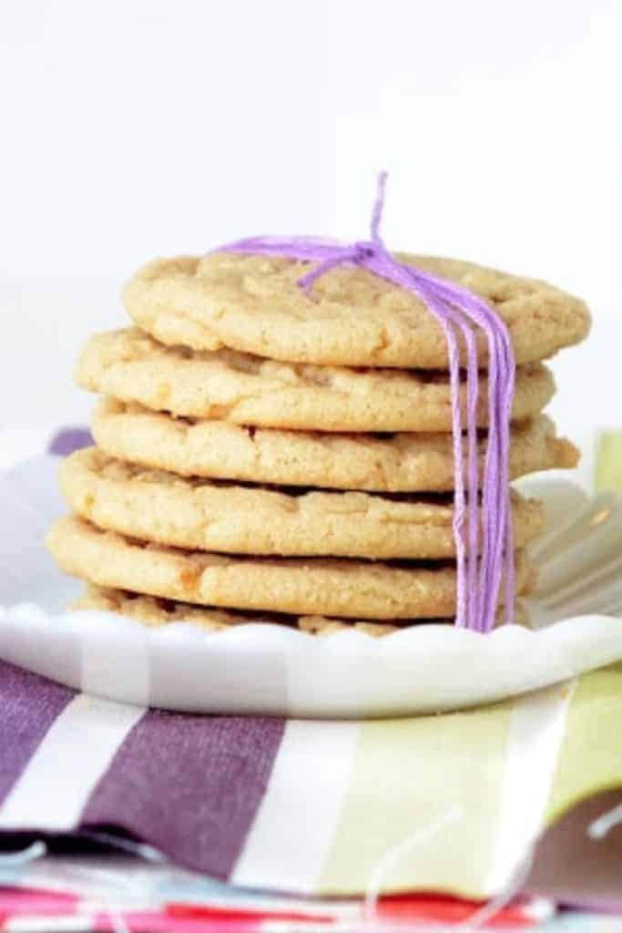 6 perfect peanut butter cookies in a stack and tied with a purple bow