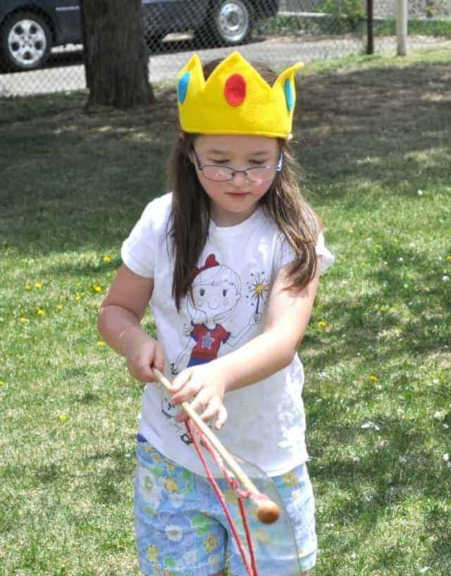 a girl wearing a felt peach's crown