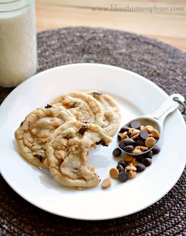 cookies on a plate with a bite taken out of one revealing peanut butter and chocolate