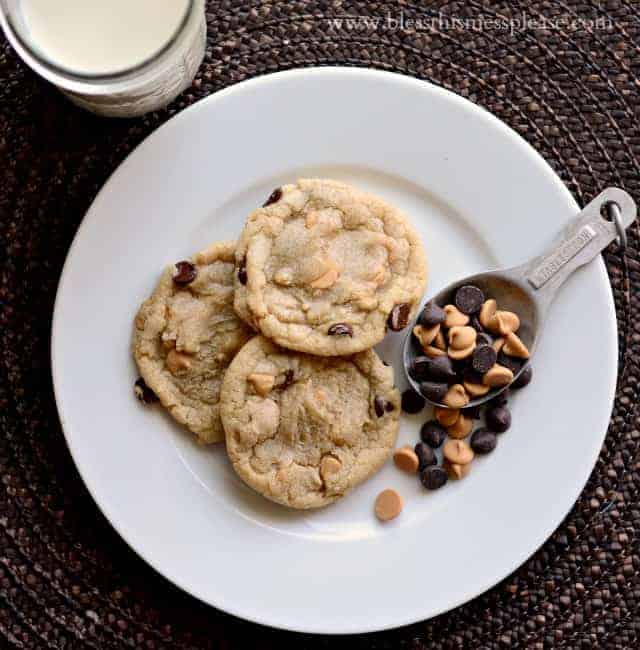 cookies on a white plate with a measuring scoop of chocolate and peanut butter chips sitting next to them