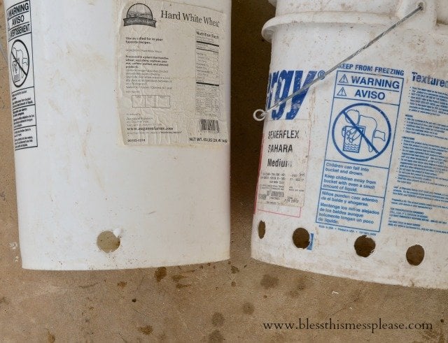 white buckets for chicken feeder and waterer.